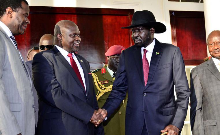 Leader of the Sudan People's Liberation Movement In Opposition (SPLM-IO) Riek Machar shakes hands with South Sudan's President Salva Kiir 