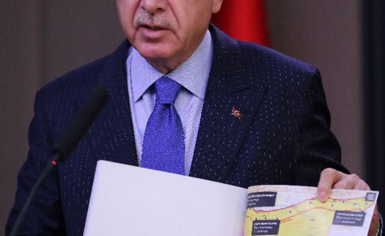Turkish President Recep Tayyip Erdogan shows a document with a map of Turkey-Syria border 