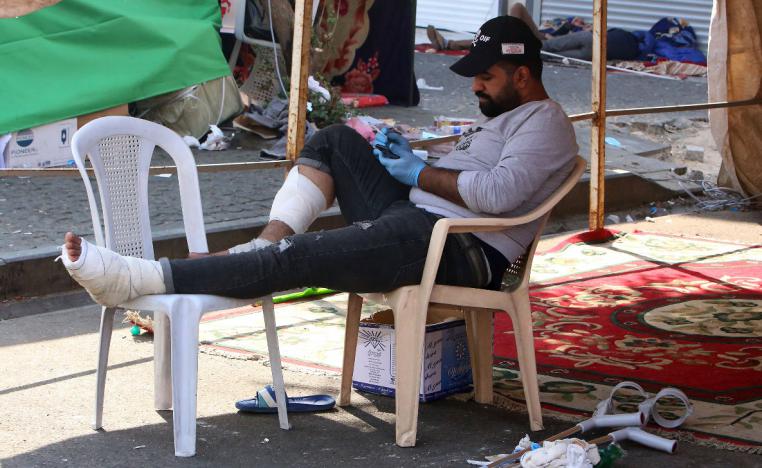 A wounded Iraqi protester resting under a tent in al-Khalani square in central Baghdad 