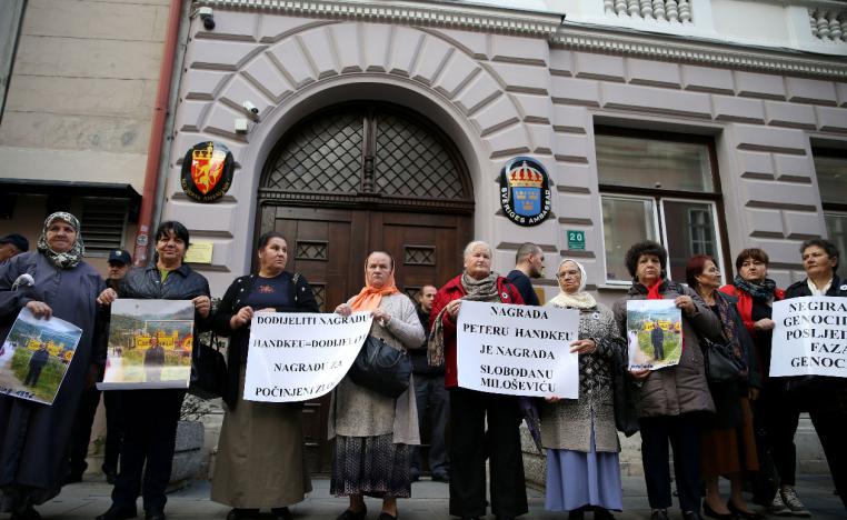 Representatives of the Association of Victims and Witnesses of Genocide hold a picture of the winner of the 2019 Nobel Prize for Literature Peter Handke in Srebrenica, during a protest in front of Sweden embassy in Sarajevo, Bosnia and Herzegovina