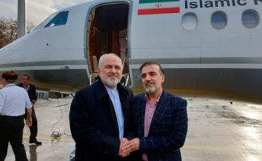 Iran's Foreign Minister Mohammad Javad Zarif shakes hands with scientist Massoud Soleimani