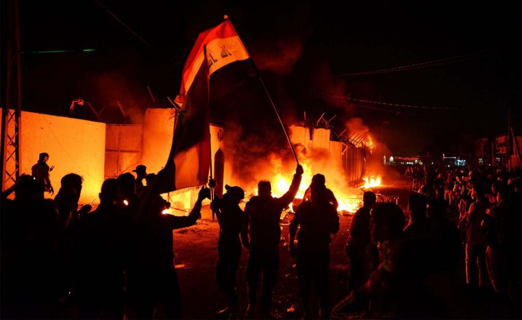 Iraqi demonstrators gather as flames start consuming Iran's consulate in the southern Iraqi Shiite holy city of Najaf 