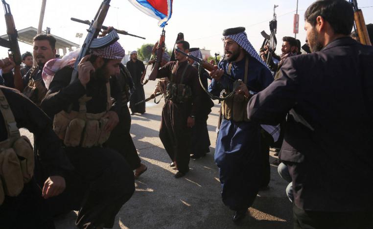 Armed tribe members take to the streets in Iraq's southern, holy city of Karbala