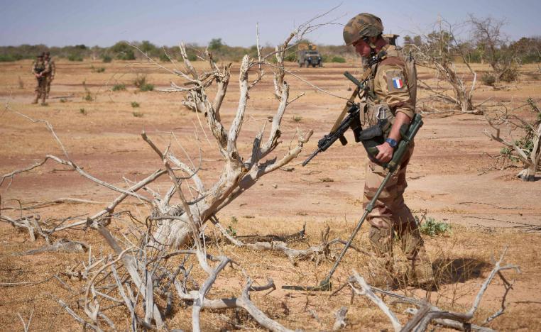 A French soldier holds a detector while searching for the presence of IEDs in northern Burkina Faso