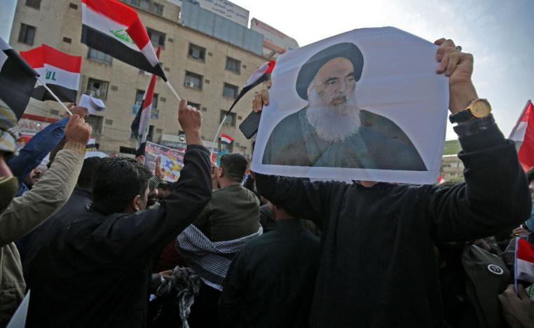 Iraqi protesters carry pictures of the country's top Shiite cleric, Grand Ayatollah Ali Sistani