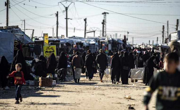People gather at a market inside the Kurdish-run al-Hol camp in northeastern Syria