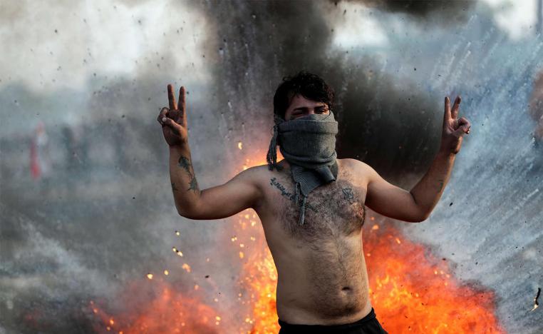 An Iraqi demonstrator gestures during ongoing anti-government protests in Baghdad