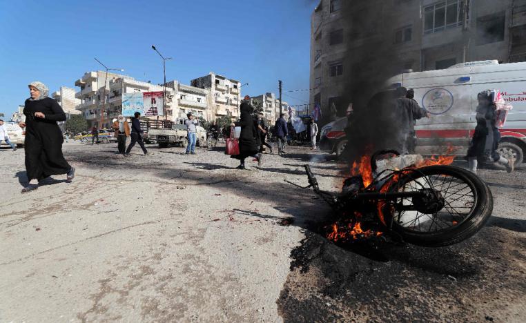 Panicked residents run following an air strike by pro-regime forces in the nothwestern Syrian city of Idlib