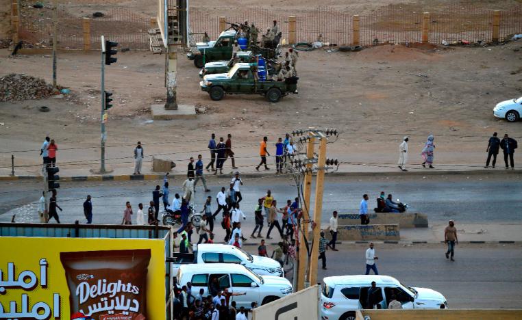 Former members of Sudan's intelligence services (background) shoot bullets in the air in the Riyadh district of the capital Khartoum