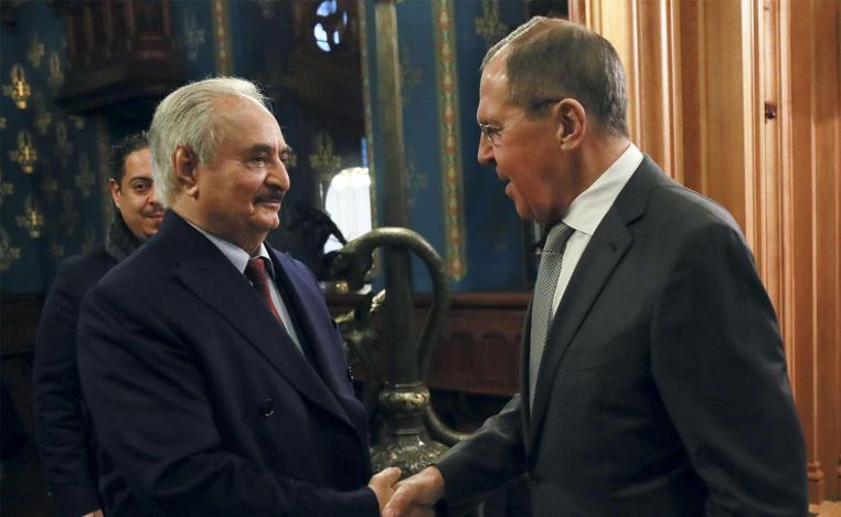 Russian Foreign Minister Sergey Lavrov, right, shakes hands with Khalifa Haftar