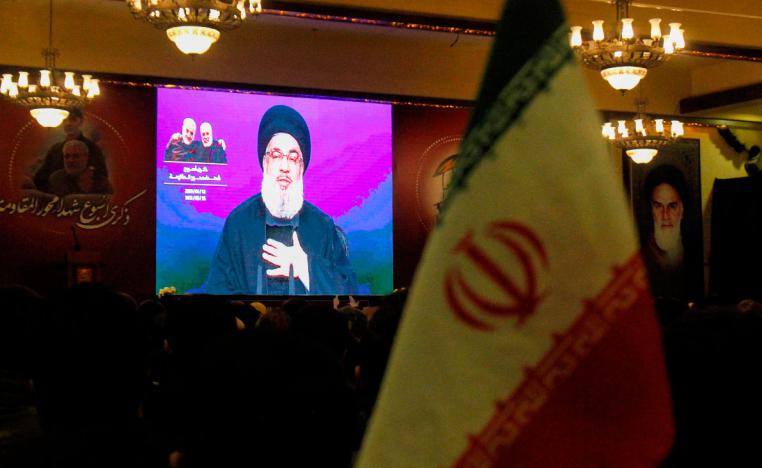 Supporters of the Shiite Hezbollah movement watch as leader Hasan Nasrallah delivers a speech