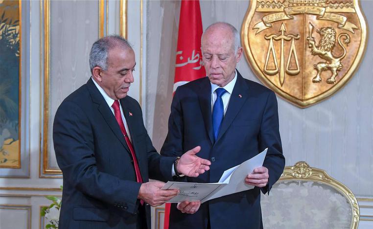 Tunisia's Prime Minister-designate Habib Jemli (L) submitting a proposed cabinet to President Kais Saied