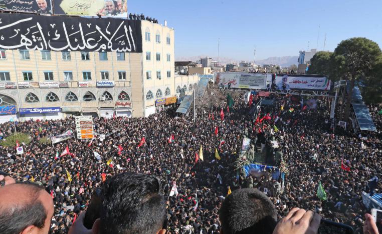 Iranian mourners gather around a vehicle carrying the coffin of slain top general Qassem Soleimani during the final stage of funeral processions, in his hometown Kerman