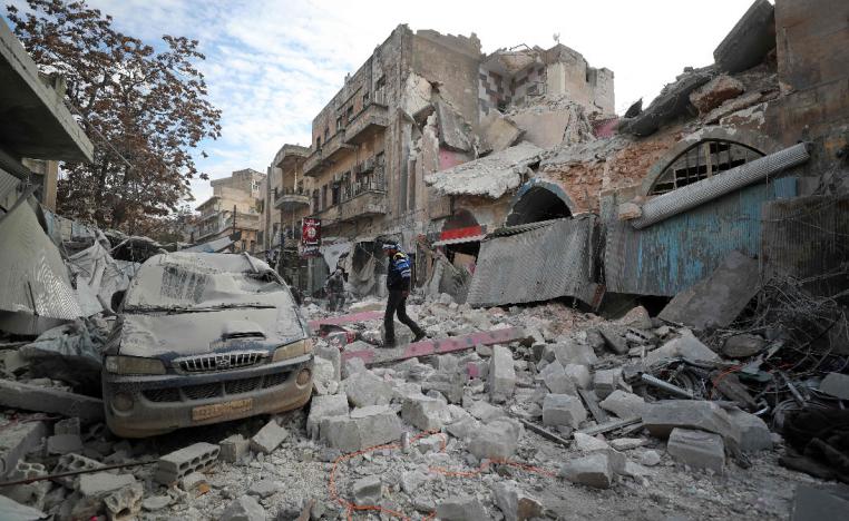 A Syrian walks on the rubble of a building following a regime air strike