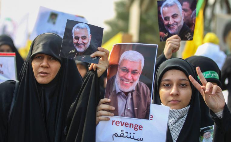 Iraqi women attend the funeral of Iranian military commander Qassem Soleimani (portrait), Iraqi paramilitary chief Abu Mahdi al-Muhandis (portrait) and eight others in Baghdad