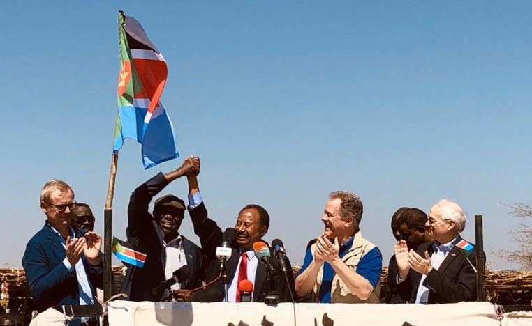 Sudanese PM Abdallah Hamdok clasps hands with rebel leader Abdelaziz al-Hilu in Kauda