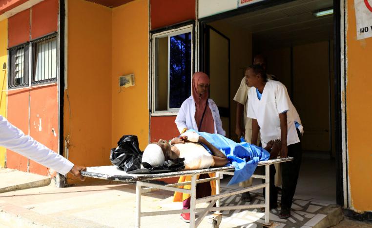 Paramedics at the Madina hospital assist an unidentified man injured in an explosion in Afgoye