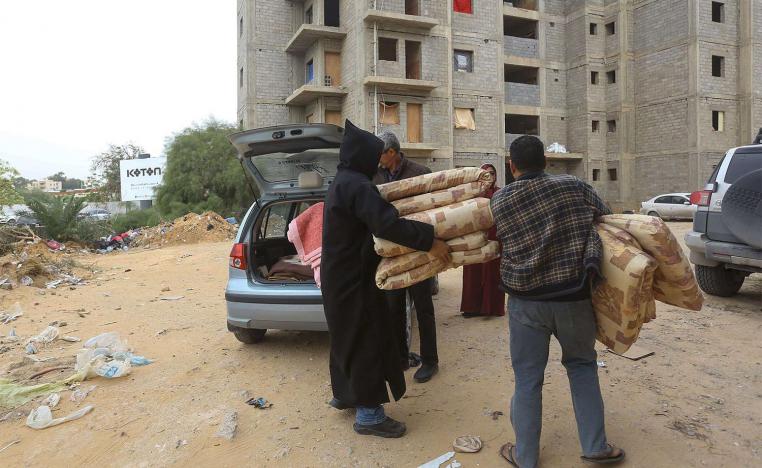 Displaced Libyans unload furniture in Tripoli