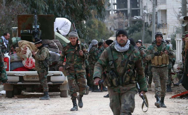 Members of the Syrian army deploy in the al-Rashidin 1 district, in Aleppo's southwestern countryside