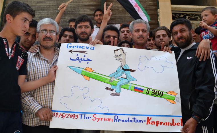 Photo taken on May 31, 2013 shows demonstrators holding a placard in Kafranbel, Idlib province