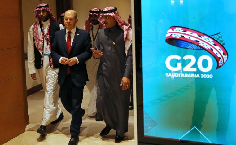 German Finance Minister Olaf Scholz and Saudi Minister of Finance Mohammed al-Jadaan walk to the G20 finance ministers and central bank governors meeting hall in Riyadh