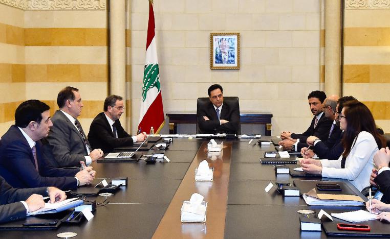 Lebanese Prime Minister Hassan Diab (C) meets a delegation from the International Monetary Fund (IMF) in Beirut