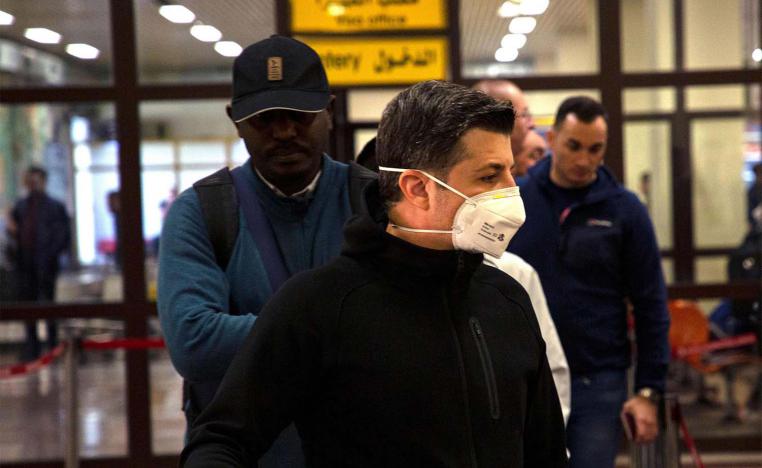 A passenger wearing a mask is pictured at Basra airport in southern Iraq