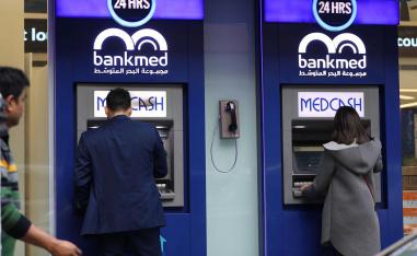 A Lebanese man withdraws money from a ATM in the capital Beirut 