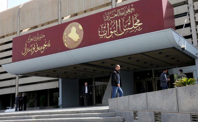 Iraqis stand outside parliament building, or Council of Representatives, in Baghdad's Green Zone