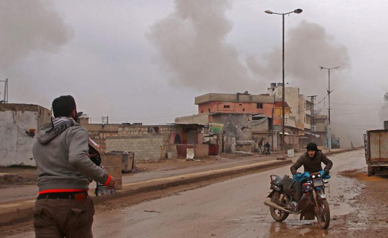 Syrian men flee the town of Atareb in the rebel-held western countryside of Syria's Aleppo province