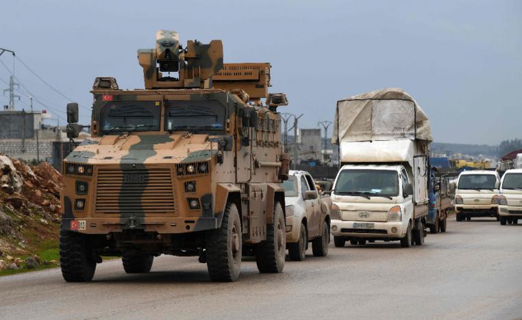A Turkish military vehicle drives toward the Bab el Hawa border crossing in Syria