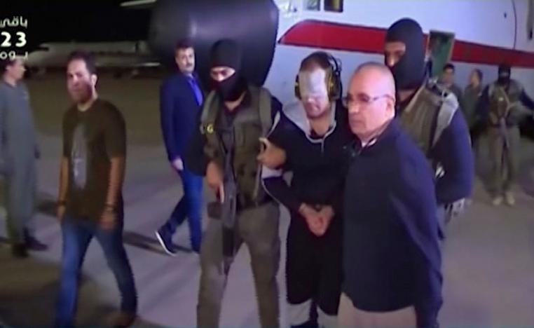 May 29, 2019 photo shows a blindfolded Hisham al-Ashmawy escorted by Egyptian military officers