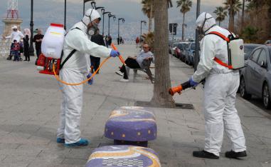 Employees from a disinfection company sanitize a bench as a precaution against the spread of the coronavirus, at Beirut's seaside Corniche
