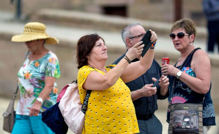 A tourist uses a phone to take pictures while on a visit to Luxor Temple in Egypt's southern city of Luxor 