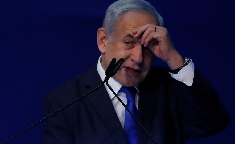 Israeli Prime Minister Benjamin Netanyahu gestures as he speaks to supporters following the announcement of exit polls in Israel's election at his Likud party headquarters in Tel Aviv