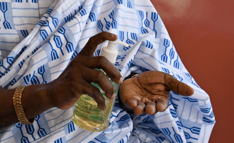A man disinfects his hands in Abidjan, Ivory Coast