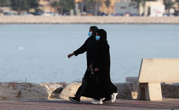 Women wear protective face masks, as they walk, after Saudi Arabia imposed a temporary lockdown on the province of Qatif