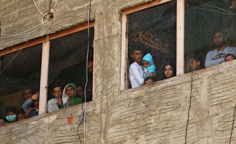 Syrian refugees pictured in a building under construction they have been using as a shelter in Sidon, Lebanon
