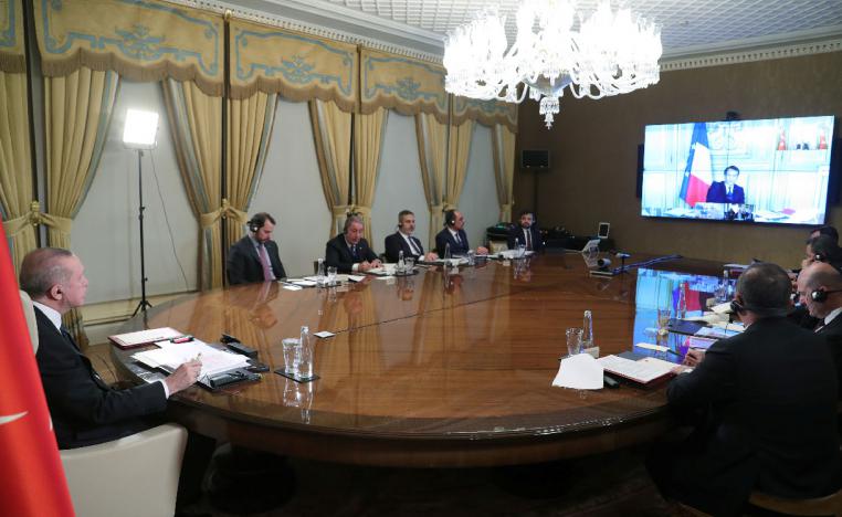 Turkish President Recep Tayyip Erdogan (L) attends a teleconference with European leaders
