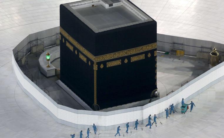 Workers disinfect the ground around the Kaaba in Mecca