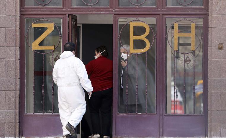 A medical expert in special gear stands at the entrance of Zekai Tahir Burak Hospital in Istanbul