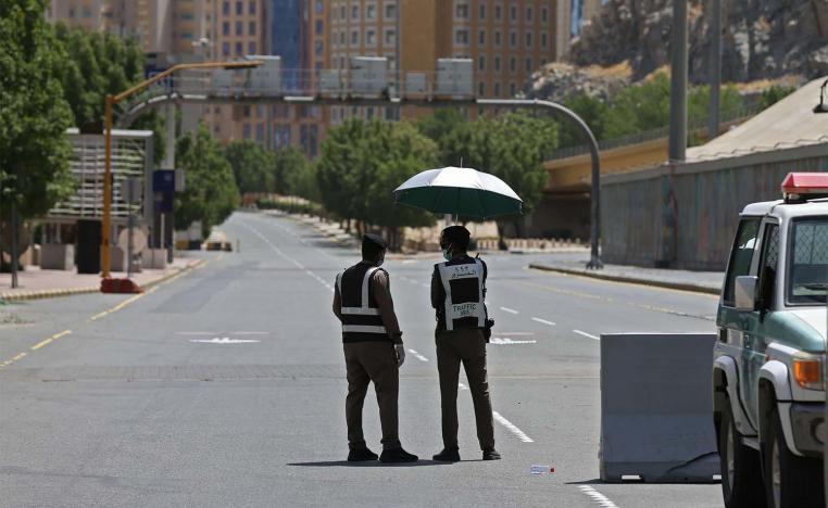 Police officers man a checkpoint in a street in Saudi Arabia's holy city of Mecca
