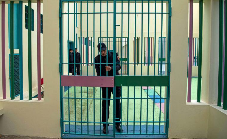 A prison warden locks a gate at the Oukacha prison in Casablanca