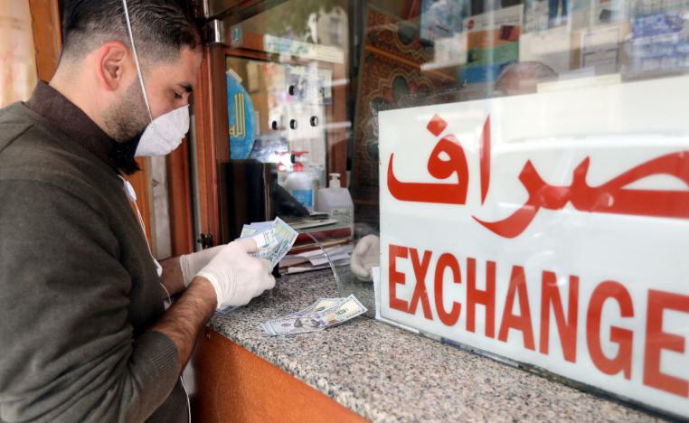 A customer is served at the counter of a currency exchange store in Beirut