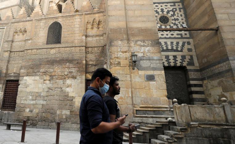 Men are seen walking as mosques are closed in old Islamic Cairo, Egypt