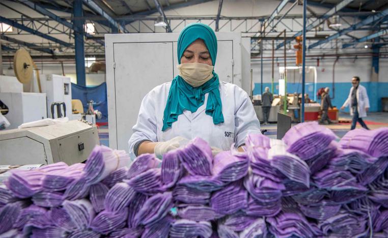 A factory worker packages disposable protective masks along a production line in Morocco's Casablanca 