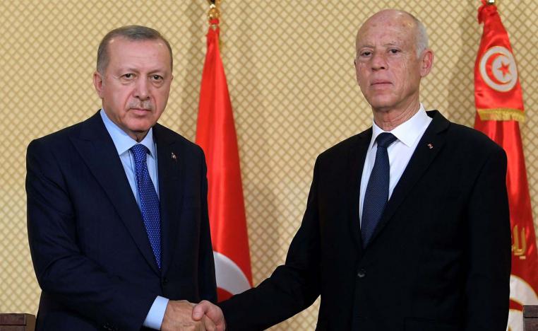 Tunisian President Kais Saied (R) shakes hands with Turkish President Recep Tayyip Erdogan during a joint press conference at the presidential palace in Carthage in December 2019