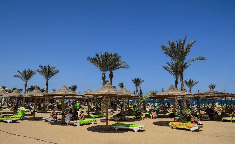 Tourists sunbathe on a beach in Egypt's Red Sea resort town of Hurghada on APril 2019