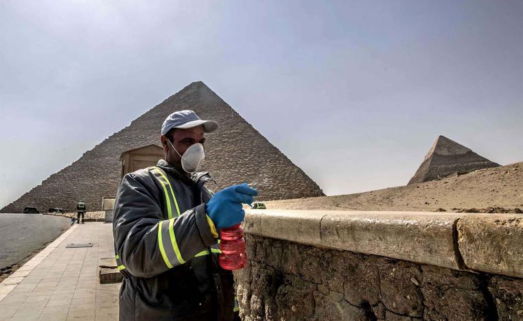 Egyptian municipality workers disinfect the Giza pyramids necropolis on the southwestern outskirts of Cairo