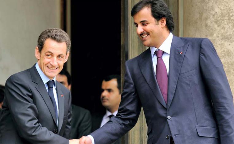 Fromer French President Sarkozy shaking hands with Qatar's emir